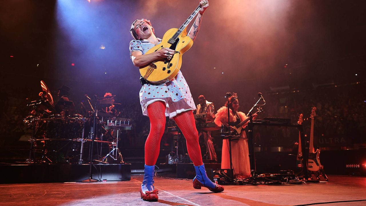 Harry Styles performs, in Dorothy from &quot;The Wizard of Oz&quot; costume, with Toto dog onstage at Harry Styles &quot;Harryween&quot; Fancy Dress Party at Madison Square Garden on October 30, 2021 in New York City.