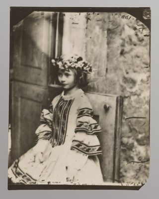 Alice Liddell with a wreath on her head.