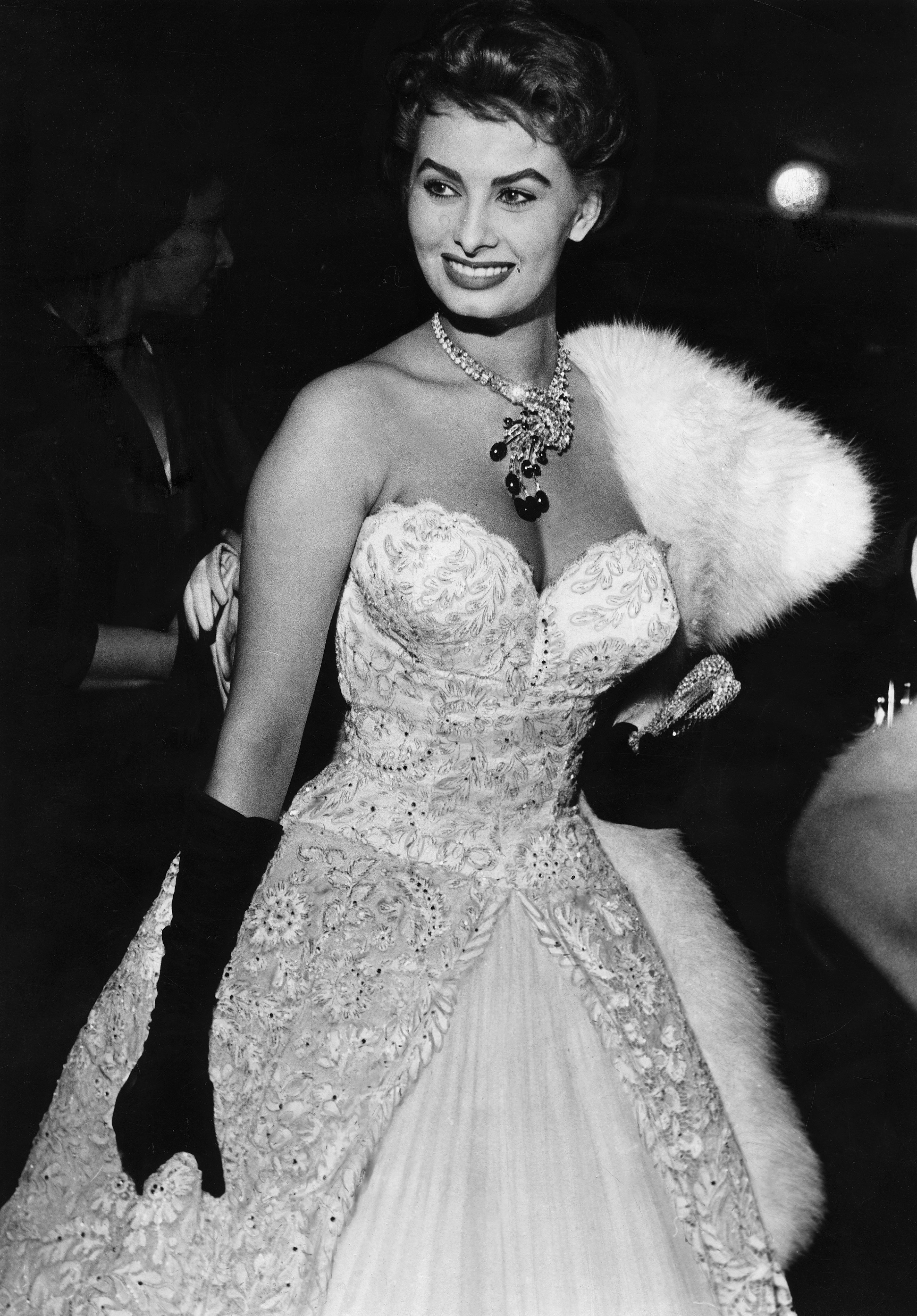 sophia loren wearing a strapless gown with black elbow-length gloves at the cannes film festival