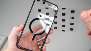 A Dbrand Ghost 2.0 case on a white Google Pixel 10 Pro XL