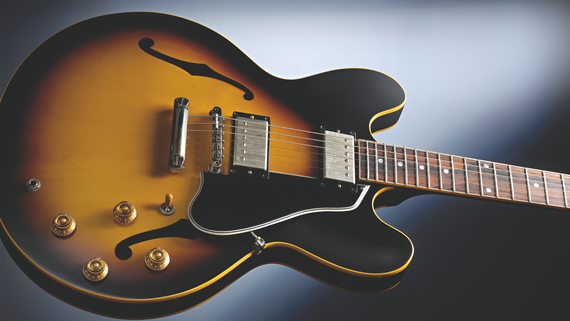 A Gibson ES-335 semi-hollow guitar on a white and black background