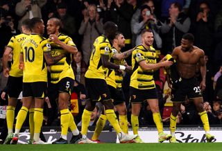 Watford’s Emmanuel Dennis (right) celebrates scoring their side’s fourth goal of the game with team-mates during the Premier League match at Vicarage Road, Watford. Picture date: Saturday November 20, 2021