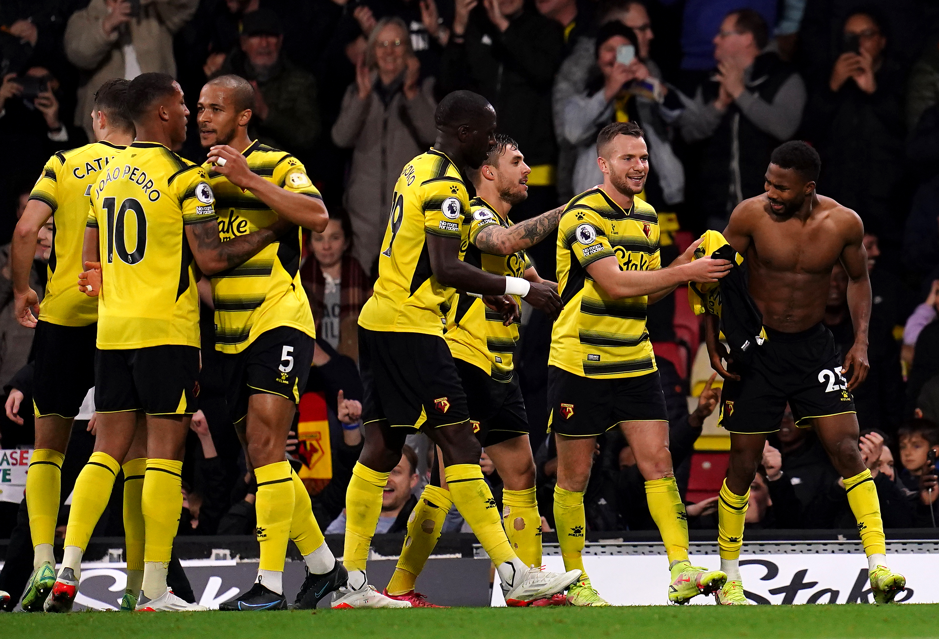 Watford’s Emmanuel Dennis (right) celebrates scoring their side’s fourth goal of the game with team-mates during the Premier League match at Vicarage Road, Watford. Picture date: Saturday November 20, 2021