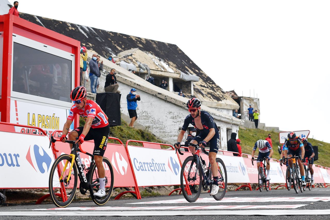 Primož Roglič hands over his red jersey after stage three