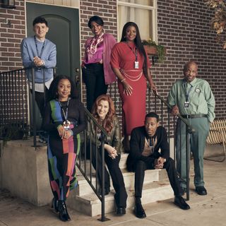 the cast of abbott elementary poses on the steps of the school