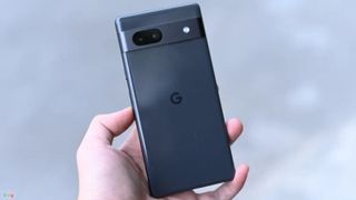 A phone that could be the Pixel 7A being held by a person