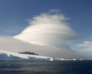 Lenticular clouds, like the ones seen in Antarctica (shown here), are so smooth and round that they're sometimes mistaken for UFOs. Like some other cloud formations, including wave clouds, lenticular clouds form because of the vagaries of winds around mou