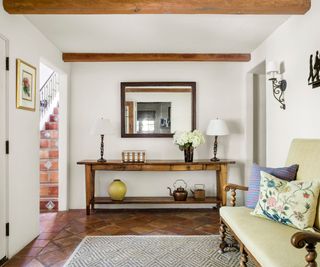 Spanish Colonial hallway with vintage and modern decor displayed on a console table