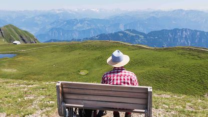 photo of a person sitting on a bench 