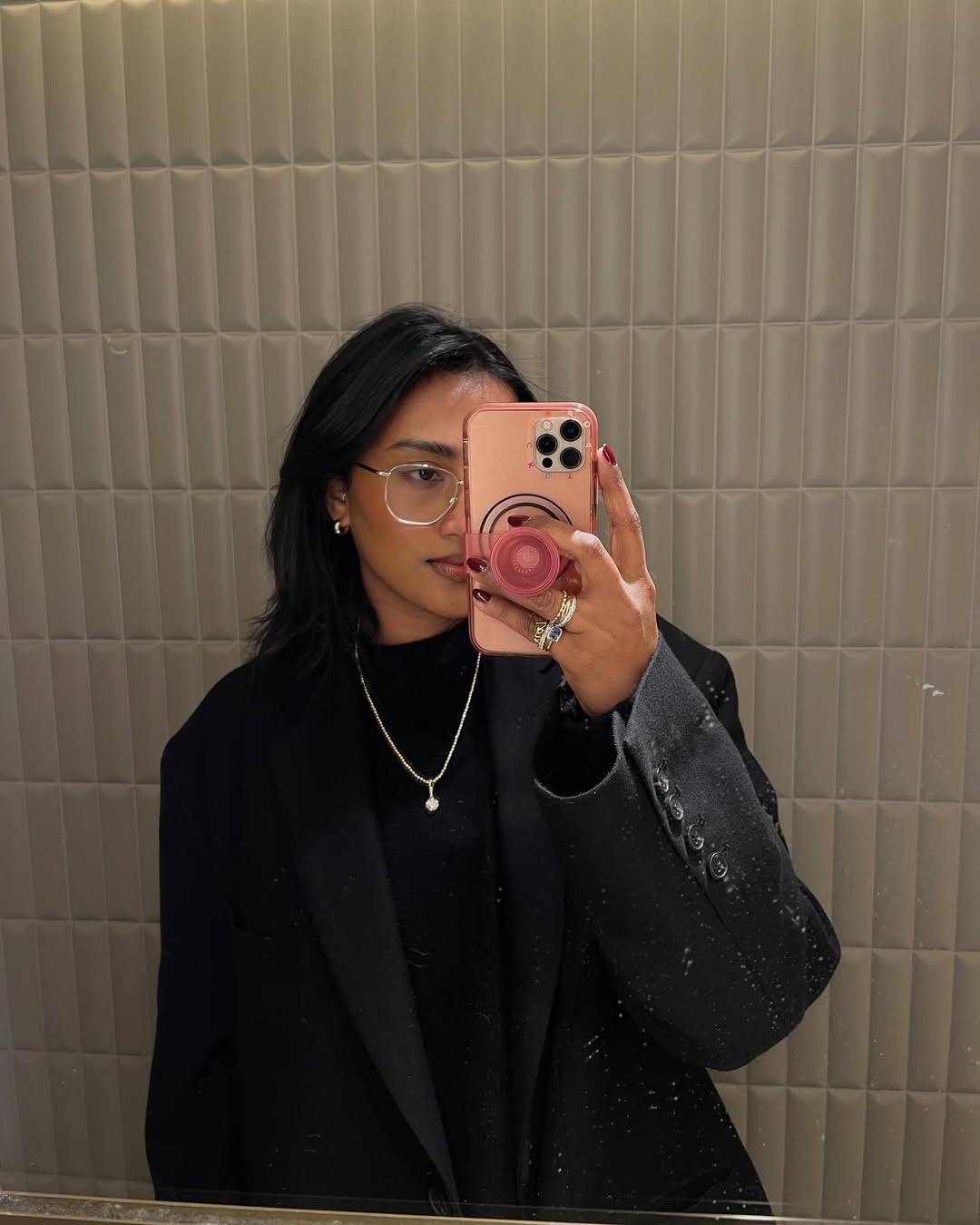 Chiara wearing silver rings, necklace, and earrings