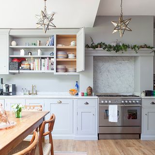Pale blue kitchen with star pendants