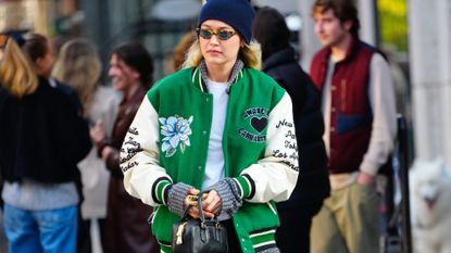 Gigi Hadid in a green varsity jacket