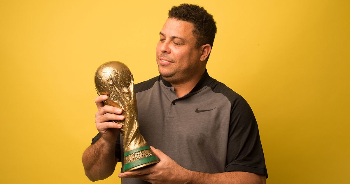 Ronaldo Nazario looks at his 2002 FIFA World Cup winners trophy for Brazil during a photo session on March 12, 2018 in Madrid, Spain.