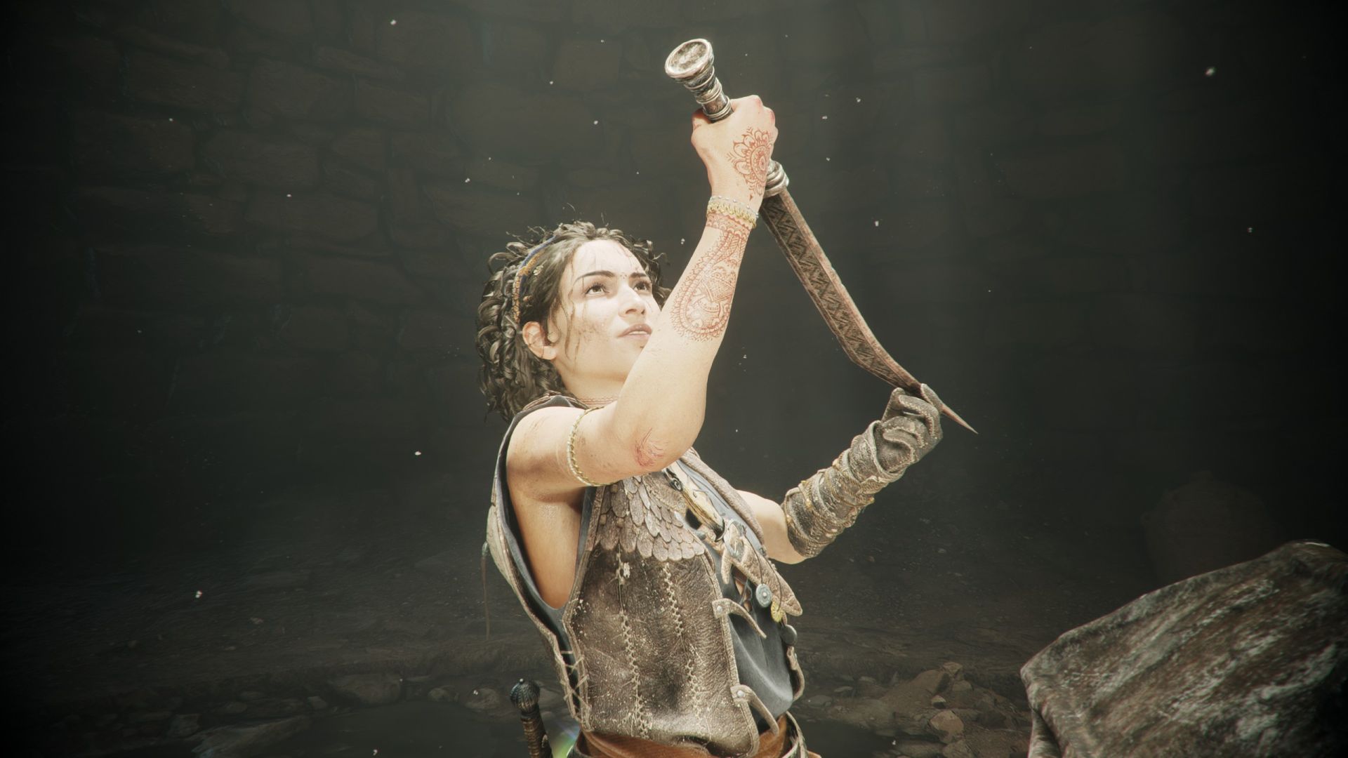 Sophia holds an ancient sword into the light