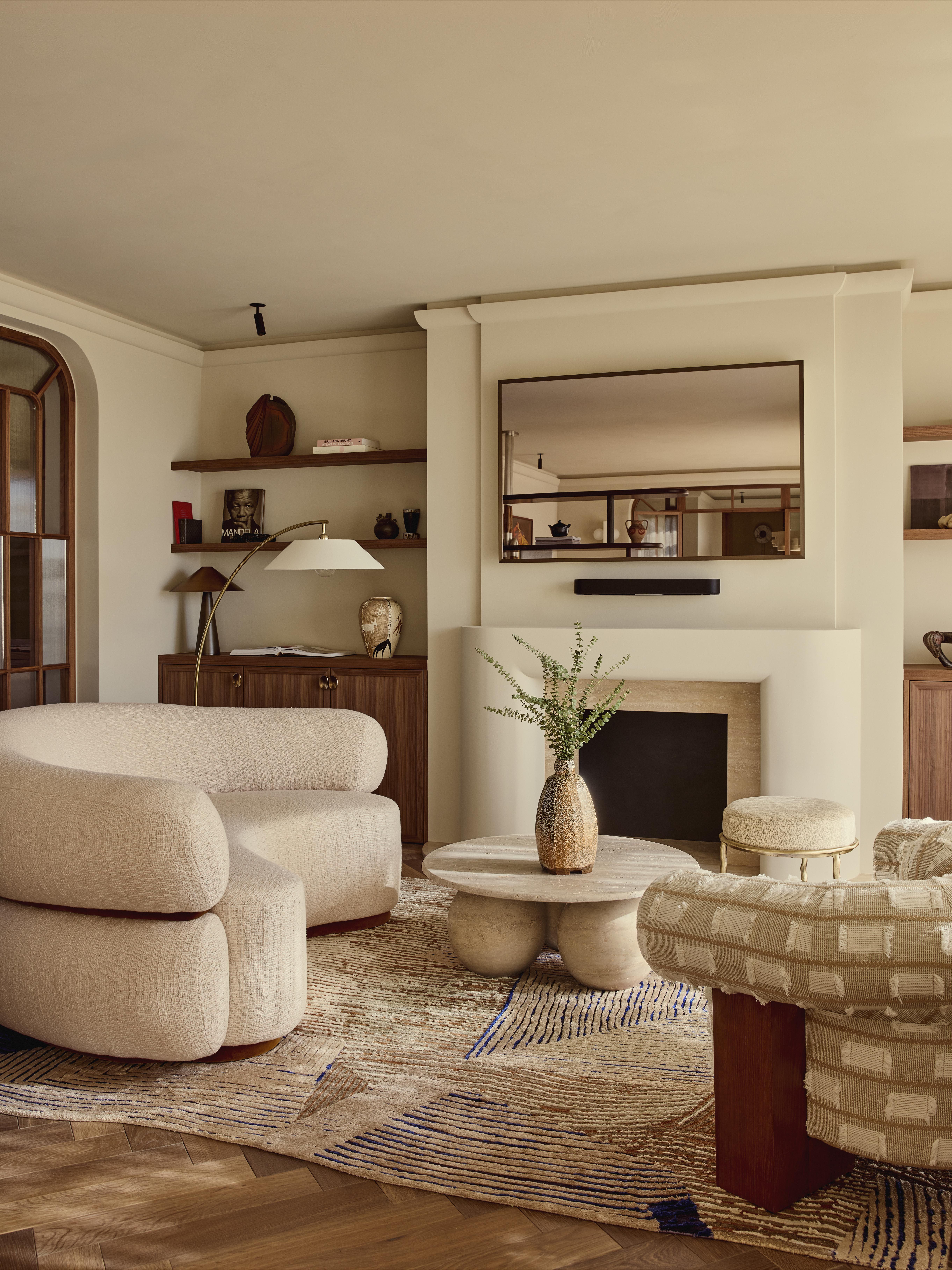 Large rug with curved seating and mirror TV and floating shelves