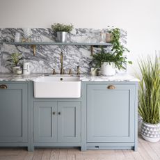 Blue shaker kitchen with butlers sink