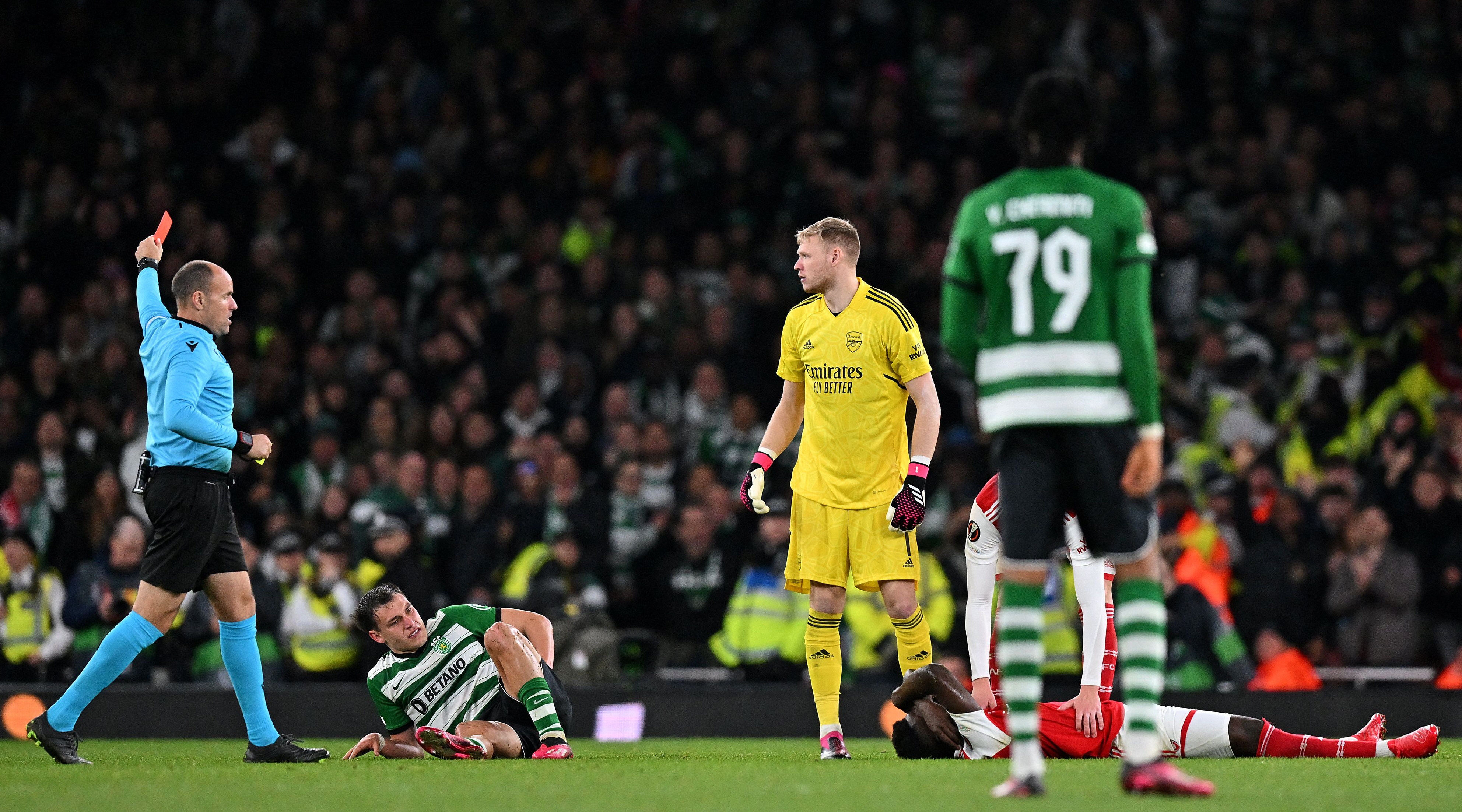 Referee Antonio Mateu Lahoz shows Manuel Ugarte of Sporting Lisbon a second yellow card for a foul on Bukayo Saka of Arsenal during the UEFA Europa League last 16 second leg match between Arsenal and Sporting Lisbon at the Emirates Stadium on March 17, 2023 in London, United Kingdom.