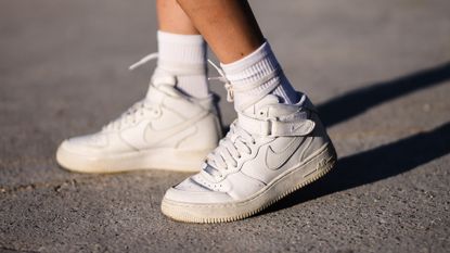 Emy venturini wears white ribbed Calzedonia socks, white shiny leather Court Borough Mid 2 sneakers from Nike, on August 25, 2021 in Paris, France