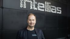 The Intellias co-founder Vitaly Sedler standing in front of the company logo