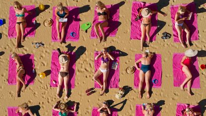 Aerial shot of women sunbathing on a beach