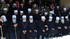 Druze clerics attend the funeral of members of the Syrian minority who were killed in recent sectarian clashes