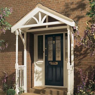black front door with open white timber canopy porch