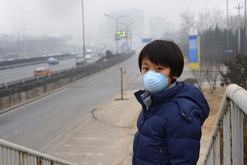 boy wearing a face mask in beijing against pollution