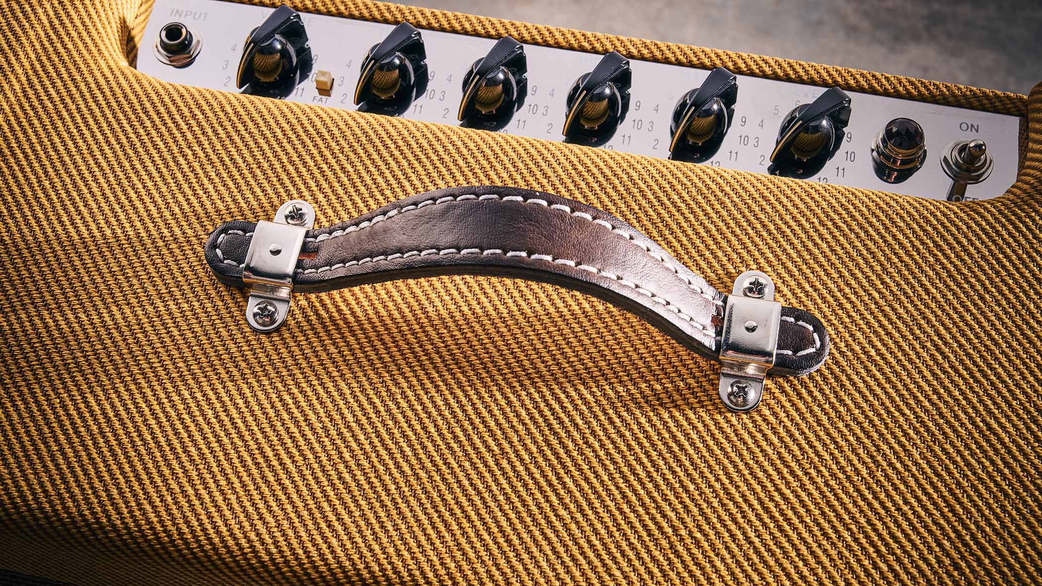 Close-up of the tweed Fender Blues Junior&#039;s control panel.