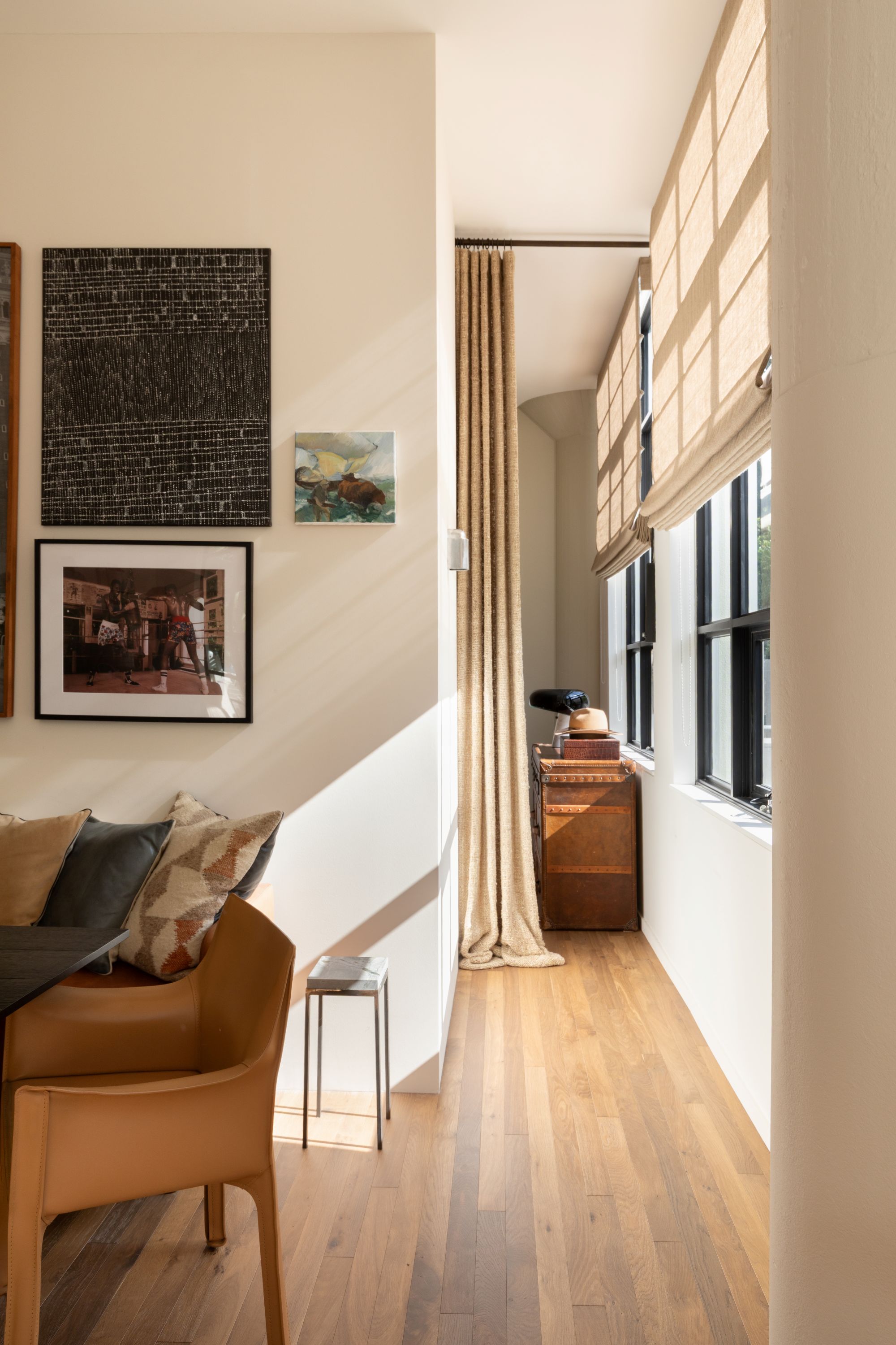 a hallway with white paint and a long curtain to divide the space