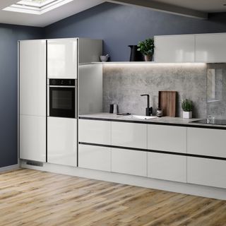 kitchen with wooden flooring and cabinets and refrigerator