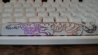 A white Ducky One 3 mechanical keyboard on a wooden desk.