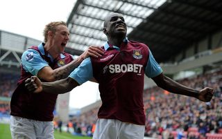 Demba Ba celebrates with Jack Collison after scoring against Wigan Athletic