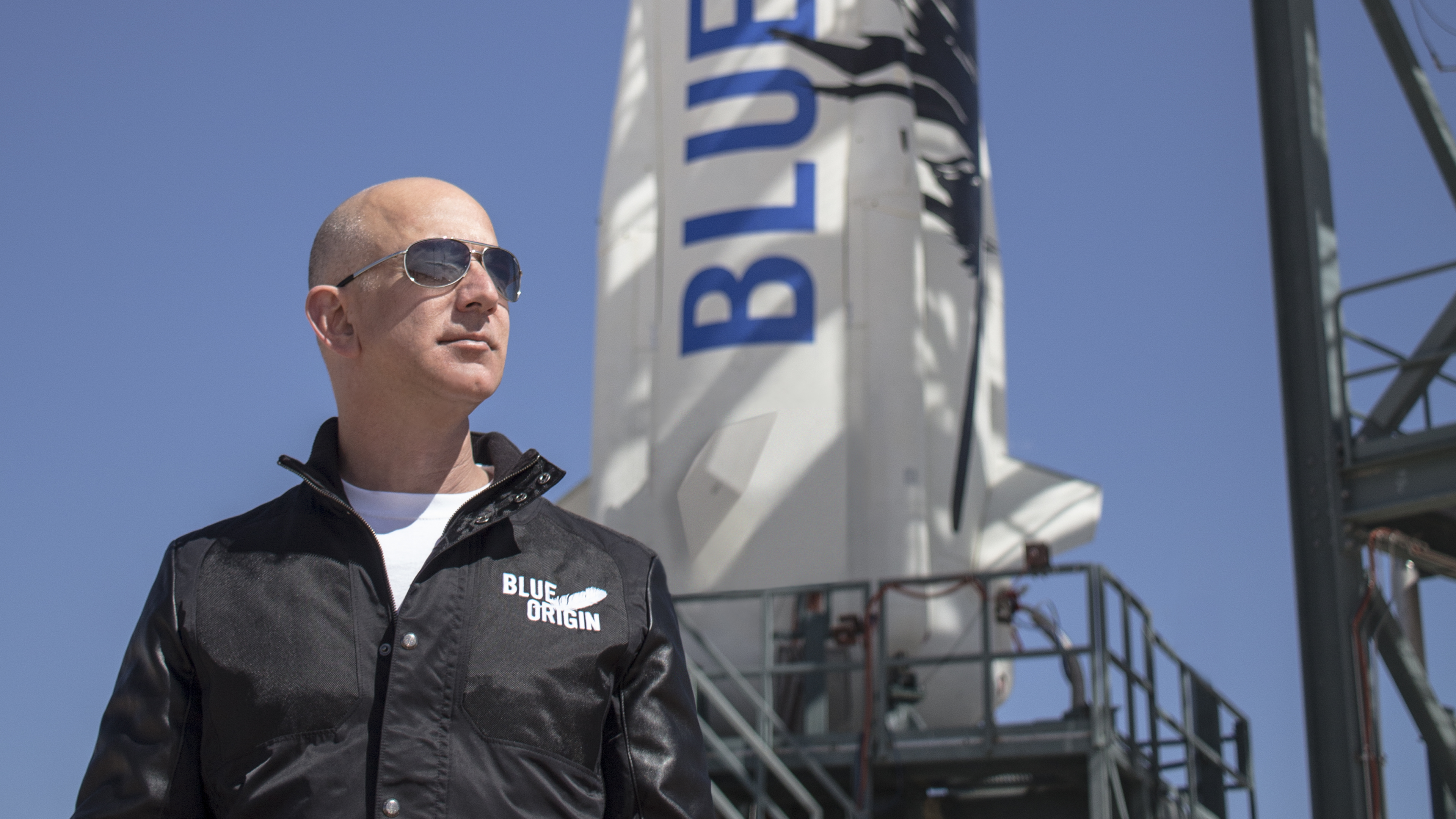 Blue Origin founder Jeff Bezos stands near his firm&#039;s New Shepard rocket before its maiden voyage. Blue Origin launched the same rocket and crew capsule on its third test flight, which included a successful landing in West Texas, on April 2, 2016.