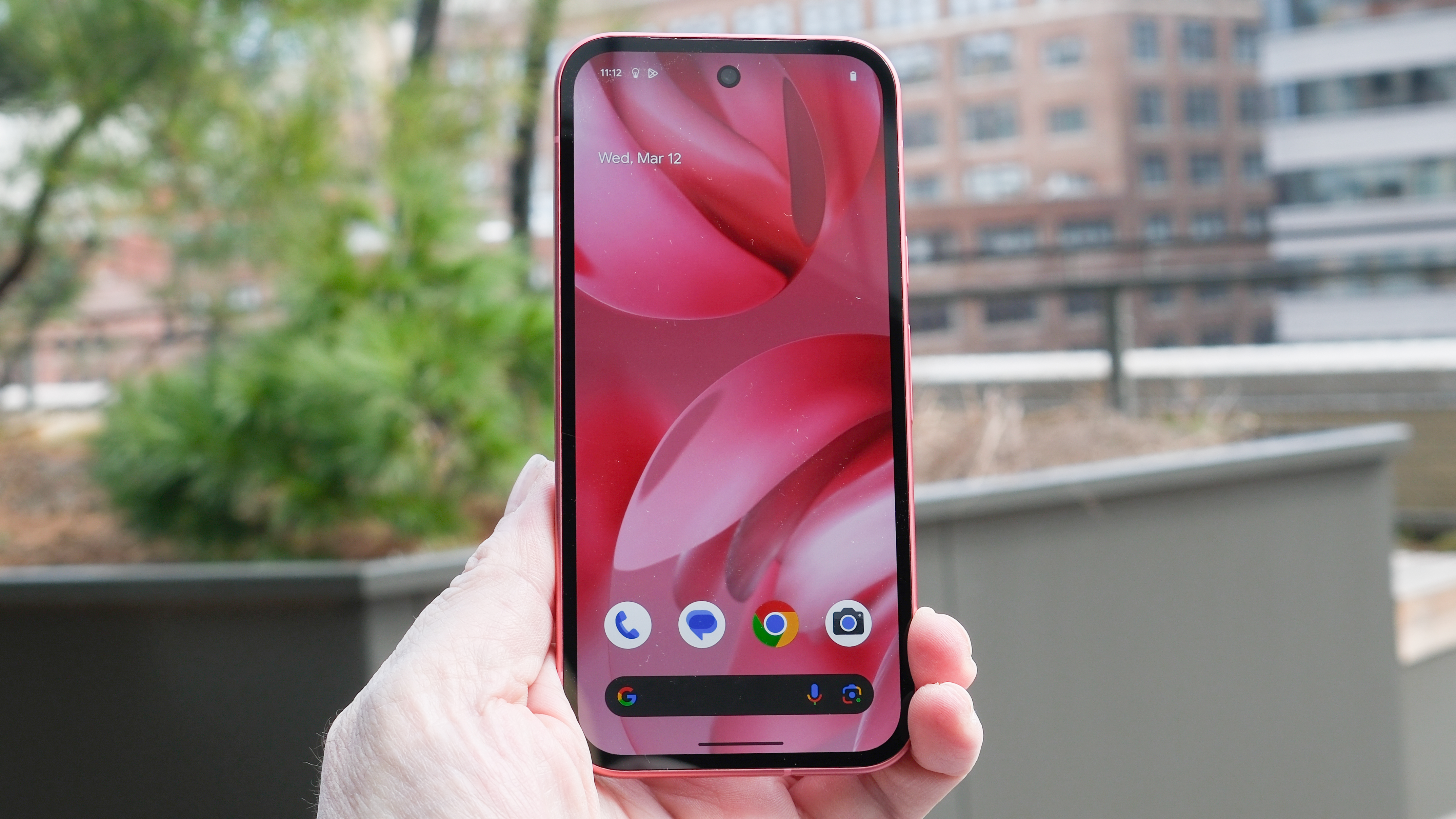 Google Pixel 9a in black, peony pink, iris, and porcelain, showing back cover with camera and home screen