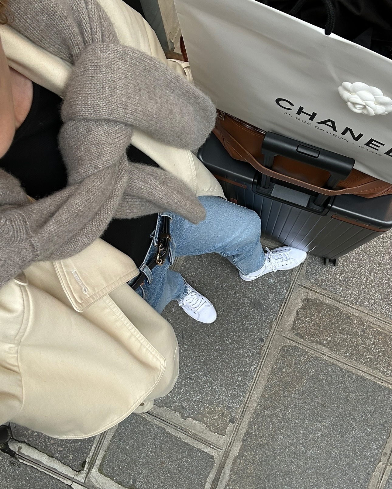 Person wearing jeans with white sneakers.