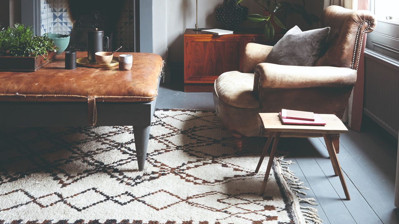 A living room with a leather armchair and ottoman