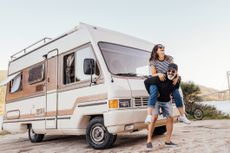 Happy couple outside a camper
