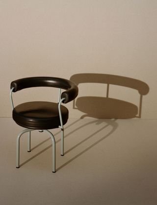 Julien T Hamon photograph of black LC7 Armchair designed by Charlotte Perriand