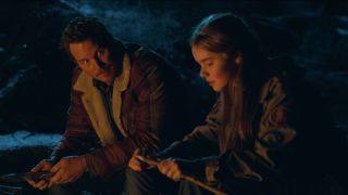 Chris Pratt and Isabella Sermon having a talk around the campfire in Jurassic World Dominion.
