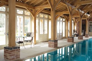 large wooden sunroom with indoor pool