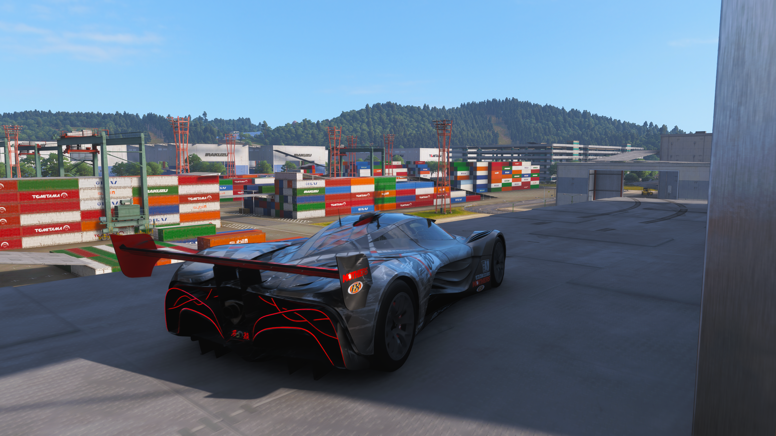Forza Horizon 6 Tokyo City Treasure Hunt location: A Mazda Furai parked on a balcony on the side of a warehouse overlooking the docks.