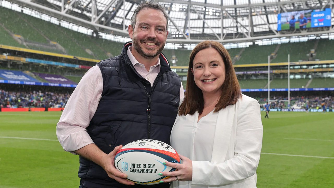 IPVanish and URC representative holding URC rugby ball in rugby stadium