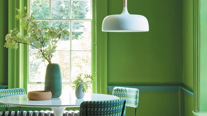 Green color drenched kitchen and dining room by Little Greene