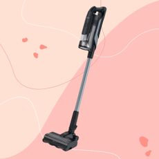 Hoover HF6 Turbo Sense Pet Cordless Vacuum on a pink background