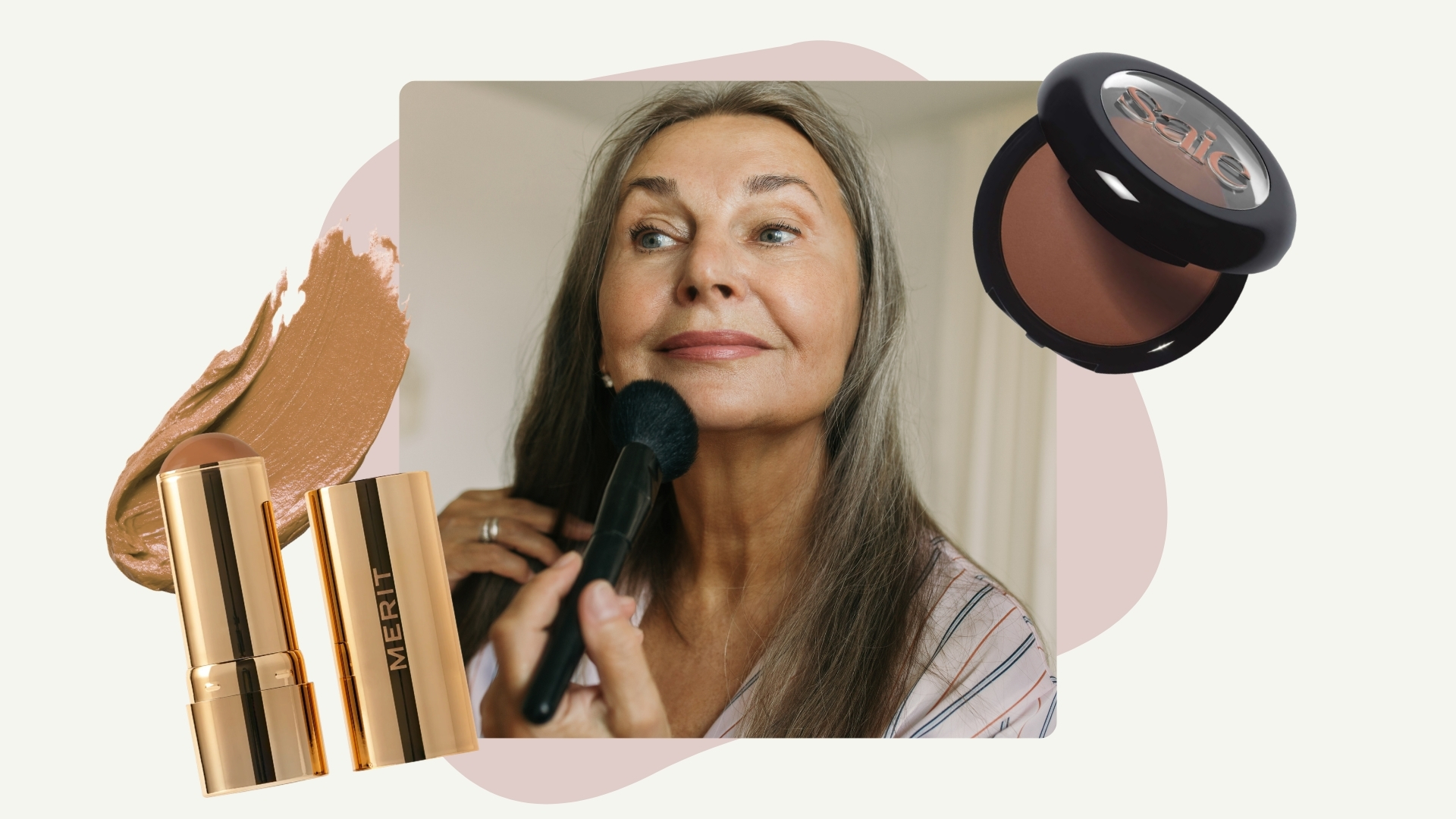 A picture of a woman with grey hair applying makeup to her face with a fluffy brush, alongside two product images of the Merit Cream Bronzer Stick and Saie SuperSuede baked bronzer/ in a cream template