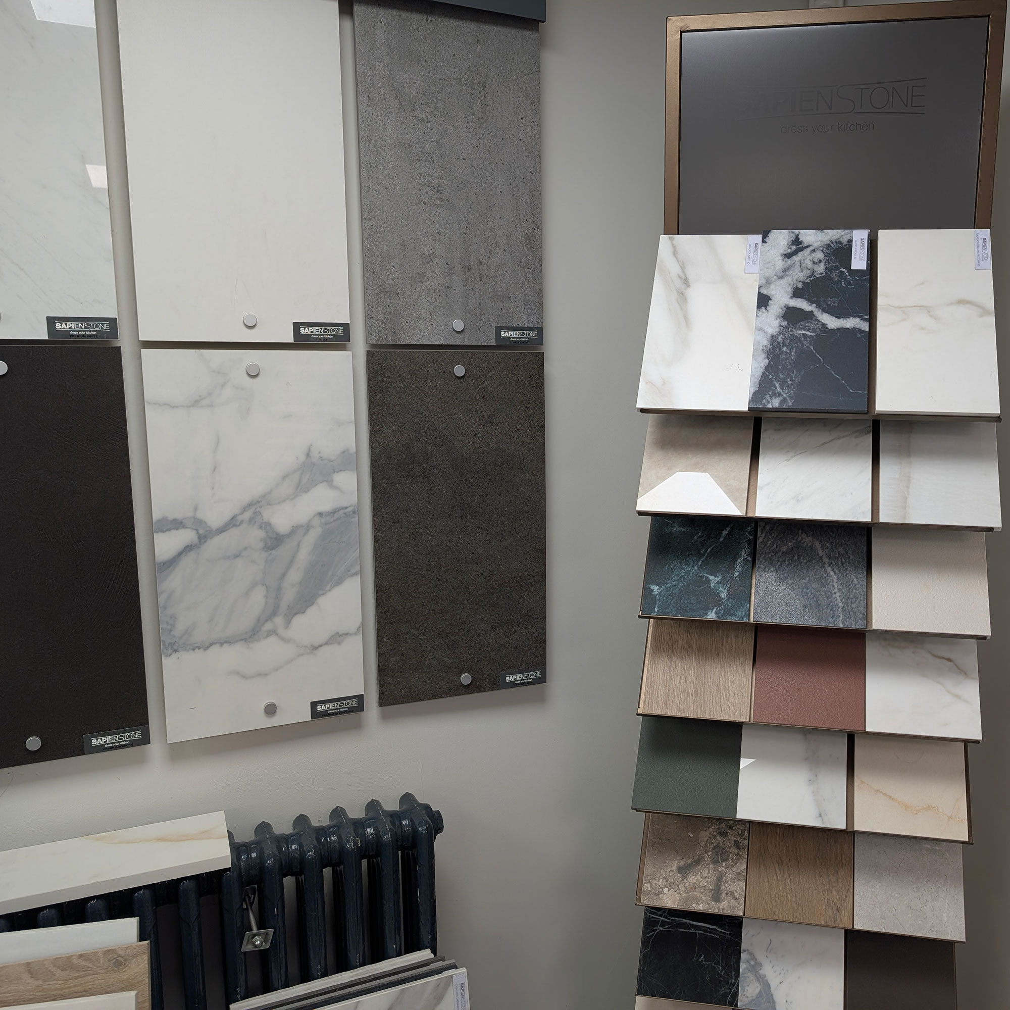 Slabs of stone and wood samples against wall in showroom