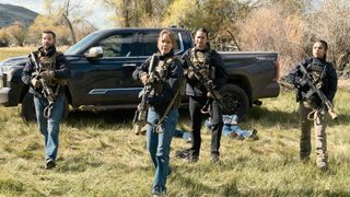 Cal, Belle, Cruz and Miles standing in full uniforms with guns drawn in front of a pickup truck with two men laying on the ground with their arms restrained in Marshals Season 2