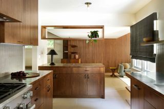Kitchen with wooden cupboards and middle island towards lounge