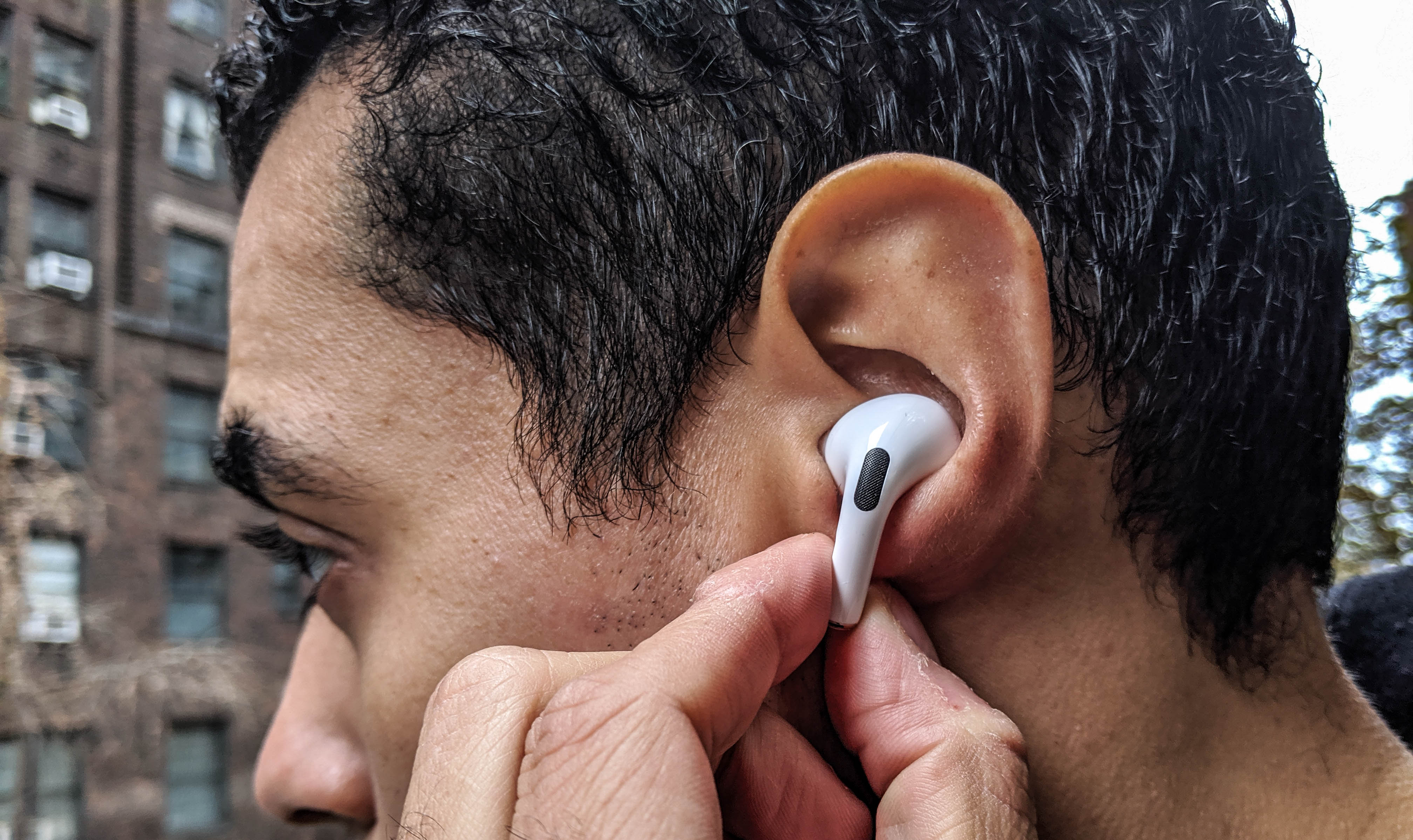Our reviewer testing the AirPods Pro's force sensors