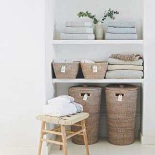 Alcove with shelves filled with blankets, towels, and storage boxes